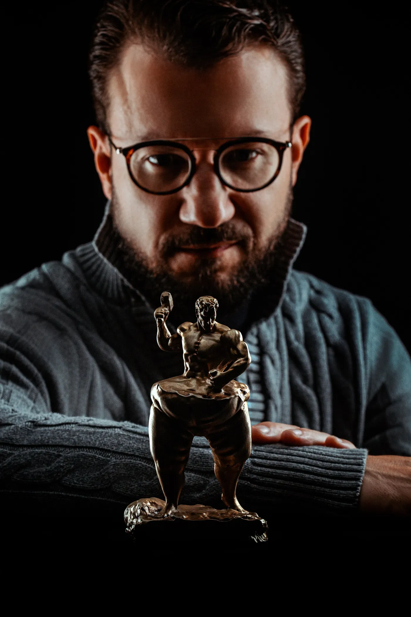 Dr. Flávio Quinalha segurando uma escultura de corpo masculino